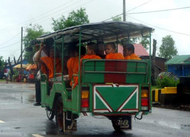 image 096-novice-buddhist-monks-getting-free-tuk-tuk-ride-in-the-rain-on-the-national-highway-4-to-phnom-penh-jpg