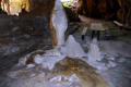 06-Stalagmite-formations-with-sunlight-coming-in-from-second-roof-collapse-window-front-view
