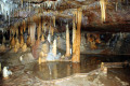 17-Assorted-speleothems-in-a-reflective-rim-pool